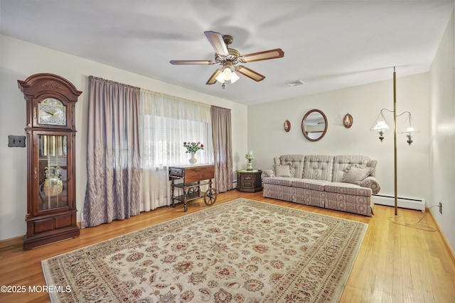 624 Lloyd Rd, Aberdeen, NJ 07747 - living room with a baseboard heating unit, ceiling fan, and wood finished floors