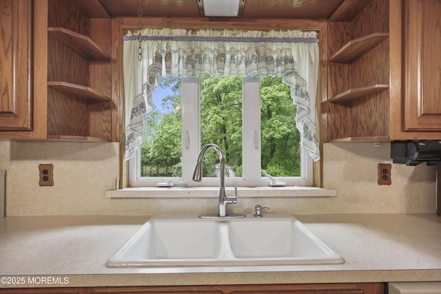 624 Lloyd Rd, Aberdeen, NJ 07747 - kitchen featuring open shelves, a sink, light countertops, tasteful backsplash, and brown cabinets