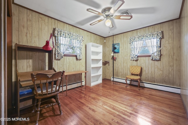 624 Lloyd Rd, Aberdeen, NJ 07747 - dining area featuring wood finished floors, healthy amount of natural light, a ceiling fan, a baseboard radiator, and wooden walls