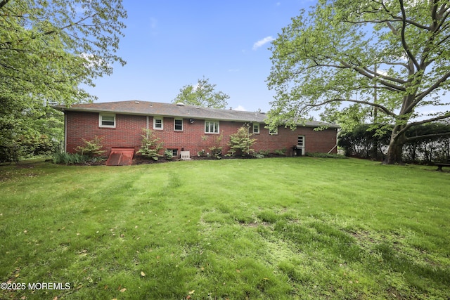 624 Lloyd Rd, Aberdeen, NJ 07747 - back of property with a lawn and brick siding