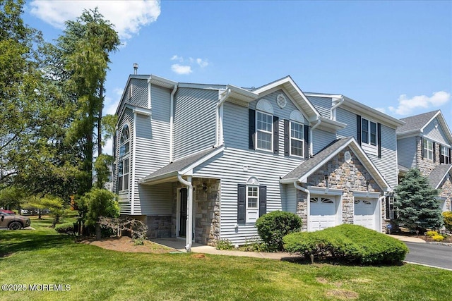 24 Hanna Ln Unit 304, Laurence Harbor, NJ 08879 - view of front facade featuring stone siding, a front lawn, and asphalt driveway