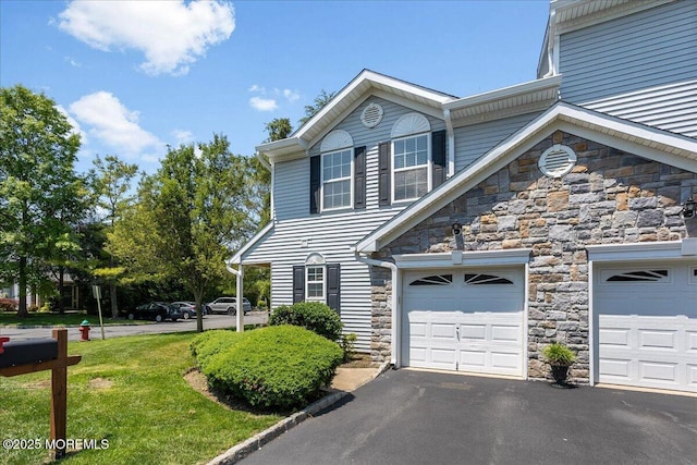 24 Hanna Ln Unit 304, Laurence Harbor, NJ 08879 - view of front of property featuring stone siding, asphalt driveway, and an attached garage