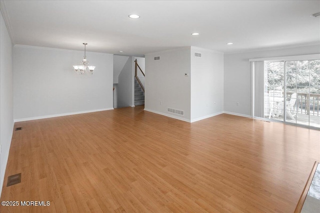 24 Hanna Ln Unit 304, Laurence Harbor, NJ 08879 - empty room with a chandelier, stairway, crown molding, light wood-style floors, and baseboards
