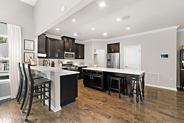 22 Imlay Ln, Farmingdale, NJ 07727 - kitchen with appliances with stainless steel finishes, a breakfast bar, ornamental molding, light countertops, and baseboards
