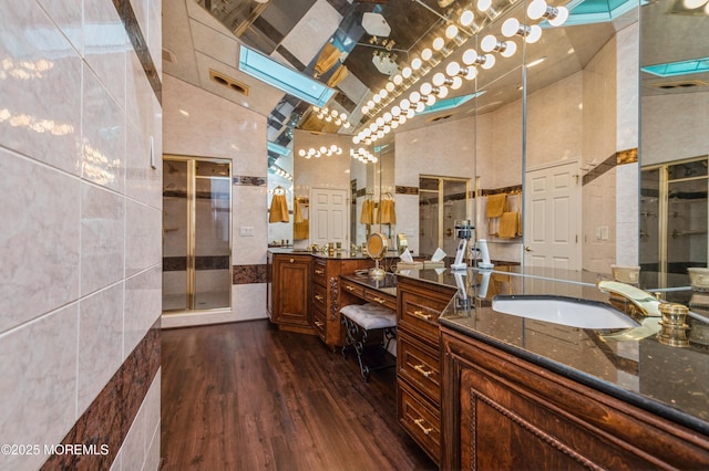 5 Stone Ln, Marlboro, NJ 07746 - bathroom with high vaulted ceiling, wood finished floors, two vanities, and a shower stall