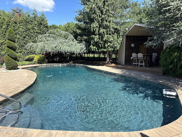 5 Stone Ln, Marlboro, NJ 07746 - outdoor pool featuring fence, a deck, and an outbuilding