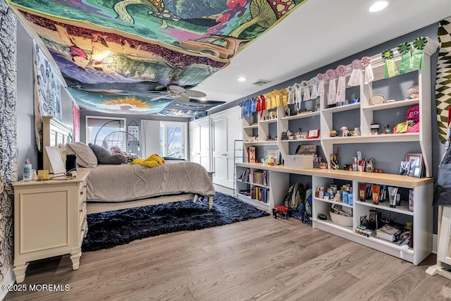 bedroom featuring wood finished floors and recessed lighting