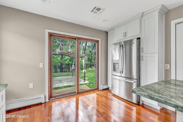 14 Santiago Dr W, Toms River, NJ 08757 - kitchen featuring stainless steel fridge with ice dispenser, baseboard heating, a baseboard heating unit, light wood-style flooring, and white cabinetry