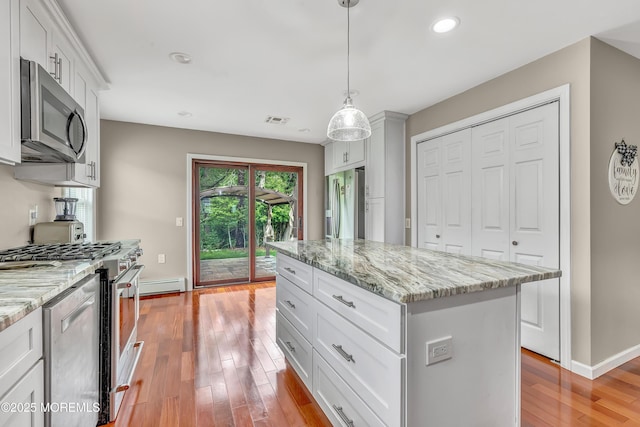 14 Santiago Dr W, Toms River, NJ 08757 - kitchen with stainless steel appliances, baseboard heating, light wood finished floors, recessed lighting, and white cabinetry