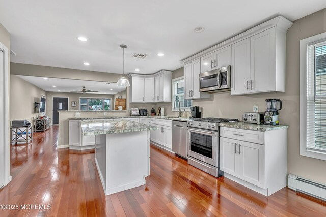 14 Santiago Dr W, Toms River, NJ 08757 - kitchen featuring stainless steel appliances, a baseboard heating unit, a peninsula, white cabinets, and light wood-type flooring