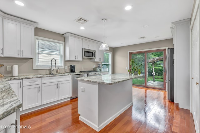 14 Santiago Dr W, Toms River, NJ 08757 - kitchen featuring stainless steel appliances, a sink, light wood finished floors, light stone countertops, and recessed lighting
