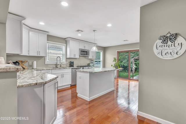 14 Santiago Dr W, Toms River, NJ 08757 - kitchen with appliances with stainless steel finishes, healthy amount of natural light, light wood-type flooring, recessed lighting, and white cabinetry
