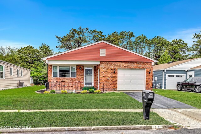14 Santiago Dr W, Toms River, NJ 08757 - single story home featuring brick siding, asphalt driveway, a front yard, and an attached garage