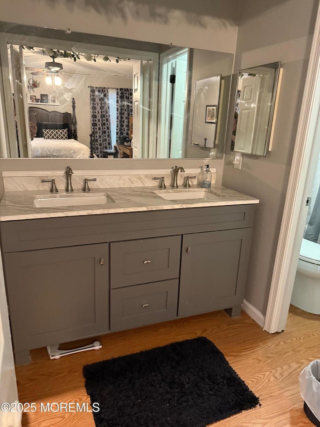 4 Capewoods Rd, North Cape May, NJ 08204 - ensuite bathroom with wood finished floors, double vanity, toilet, and baseboards