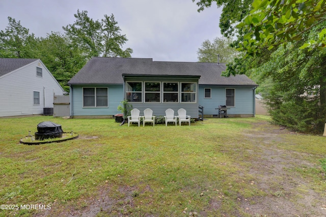 4 Capewoods Rd, North Cape May, NJ 08204 - back of house featuring an outdoor fire pit, central AC, a lawn, and a shingled roof