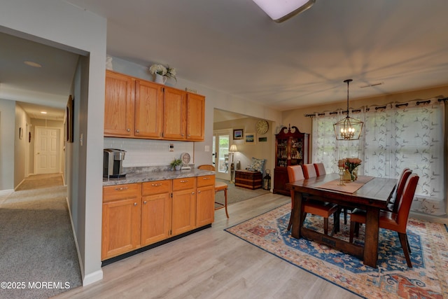 4 Capewoods Rd, North Cape May, NJ 08204 - kitchen featuring a chandelier, tasteful backsplash, pendant lighting, light wood-type flooring, and baseboards