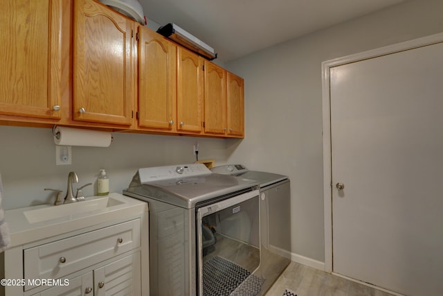 4 Capewoods Rd, North Cape May, NJ 08204 - laundry area with washer and clothes dryer, cabinet space, light wood-style flooring, and baseboards