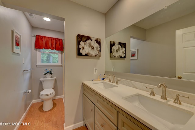 4 Capewoods Rd, North Cape May, NJ 08204 - bathroom featuring toilet, wood finished floors, double vanity, and baseboards