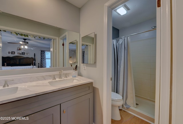 4 Capewoods Rd, North Cape May, NJ 08204 - bathroom with double vanity, toilet, wood finished floors, ceiling fan, and tiled shower