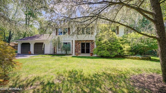 9 Toby Ter, Monroe, NJ 08831 - view of front of home featuring an attached garage, a front lawn, and brick siding