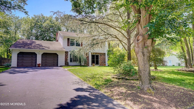 9 Toby Ter, Monroe, NJ 08831 - view of front facade with asphalt driveway, a garage, a front yard, and roof with shingles