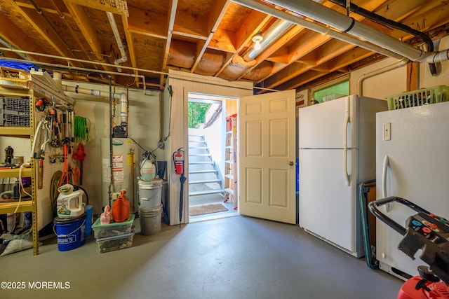 117 Waverly Pl, Howell, NJ 07731 - basement with freestanding refrigerator, water heater, and stairway