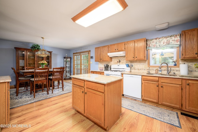 117 Waverly Pl, Howell, NJ 07731 - kitchen with white appliances, under cabinet range hood, a sink, and light wood finished floors