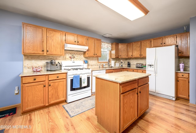 117 Waverly Pl, Howell, NJ 07731 - kitchen featuring white appliances, under cabinet range hood, light wood-type flooring, backsplash, and a kitchen island