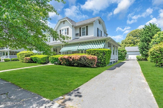 208 Ludlow Ave, Spring Lake, NJ 07762 - view of front facade featuring a front yard, a garage, and roof with shingles