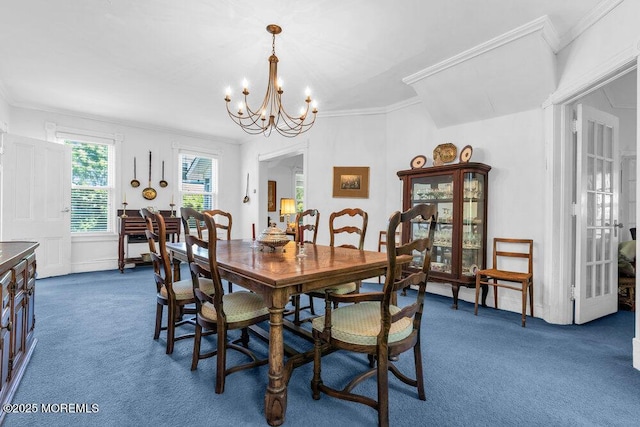 208 Ludlow Ave, Spring Lake, NJ 07762 - dining room with dark carpet, a chandelier, and crown molding