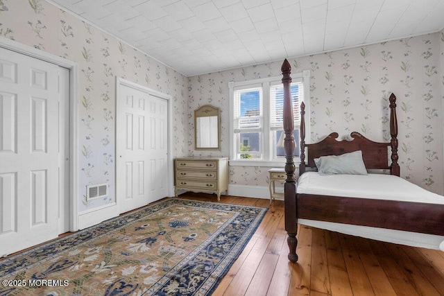 208 Ludlow Ave, Spring Lake, NJ 07762 - bedroom with wallpapered walls and hardwood / wood-style floors