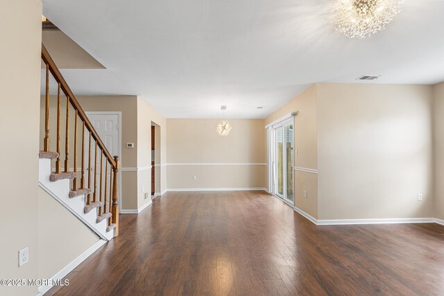7 Sloop Sq, Freehold, NJ 07728 - unfurnished room featuring a chandelier, dark wood-style flooring, baseboards, and stairway