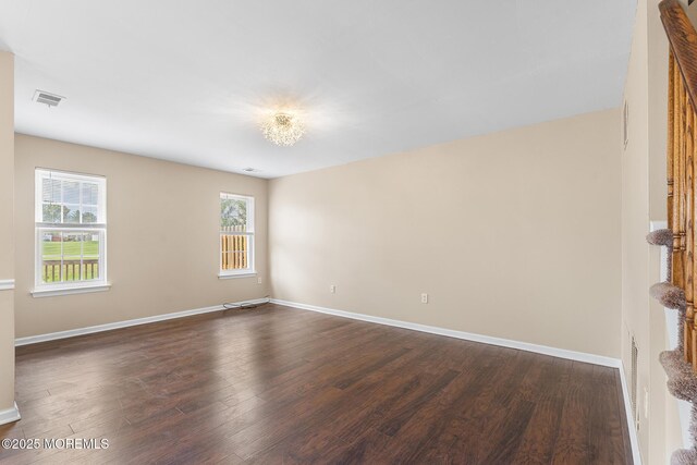 7 Sloop Sq, Freehold, NJ 07728 - empty room featuring plenty of natural light, dark wood-style floors, and baseboards