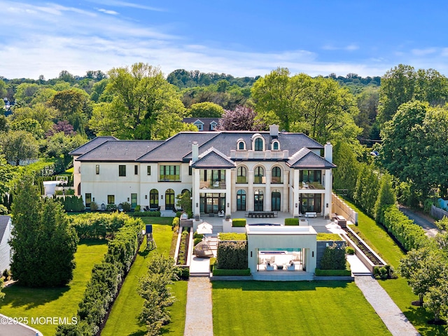 27 N Ward Ave, Rumson, NJ 07760 - back of house featuring a balcony, stucco siding, a patio, and a chimney