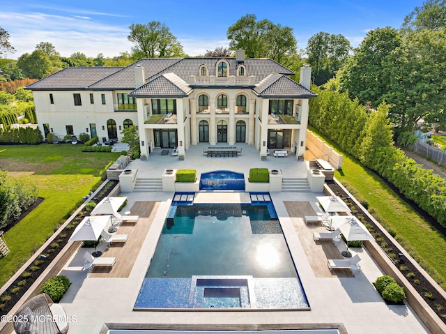27 N Ward Ave, Rumson, NJ 07760 - back of property with an in-ground hot tub, a balcony, an outdoor living space, a chimney, and a patio area