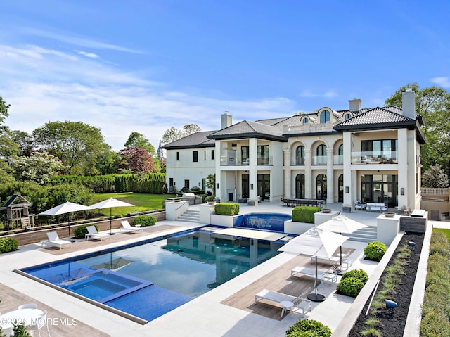 27 N Ward Ave, Rumson, NJ 07760 - back of property with a balcony, a chimney, and a patio
