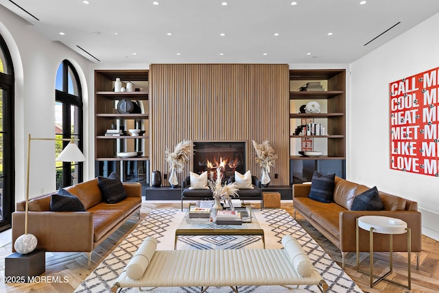 27 N Ward Ave, Rumson, NJ 07760 - living area with built in shelves, recessed lighting, and a glass covered fireplace