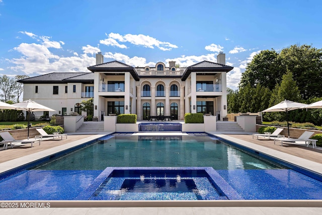 27 N Ward Ave, Rumson, NJ 07760 - rear view of property featuring a chimney, a balcony, uncovered parking, and a patio
