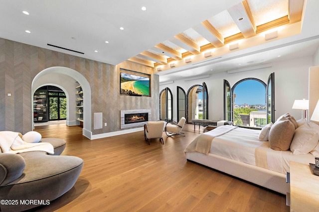 27 N Ward Ave, Rumson, NJ 07760 - bedroom with an accent wall, wallpapered walls, recessed lighting, light wood-style flooring, and a glass covered fireplace
