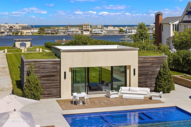 27 N Ward Ave, Rumson, NJ 07760 - rear view of property with an outdoor pool, outdoor lounge area, a deck with water view, and stucco siding