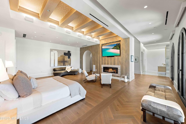 27 N Ward Ave, Rumson, NJ 07760 - bedroom featuring arched walkways, baseboards, a glass covered fireplace, and recessed lighting