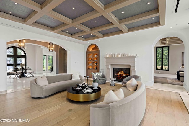 27 N Ward Ave, Rumson, NJ 07760 - living room with hardwood / wood-style flooring, coffered ceiling, healthy amount of natural light, arched walkways, and beam ceiling