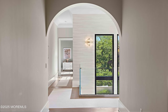 27 N Ward Ave, Rumson, NJ 07760 - hall featuring baseboards, arched walkways, and wood finished floors