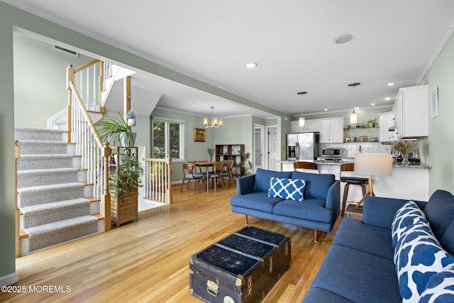 7 Beach Blvd, Highlands, NJ 07732 - living room with ornamental molding, light wood finished floors, stairway, a chandelier, and recessed lighting