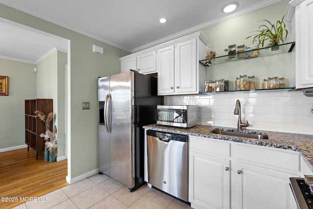 7 Beach Blvd, Highlands, NJ 07732 - kitchen with stainless steel appliances, a sink, crown molding, open shelves, and white cabinetry