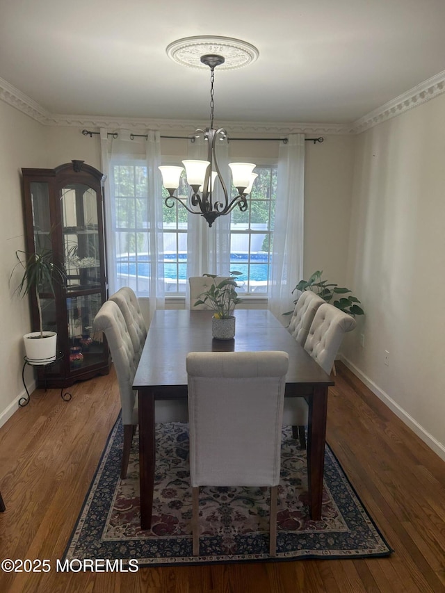 516 Montgomery Ave, Toms River, NJ 08757 - dining area with a chandelier, baseboards, wood finished floors, and ornamental molding