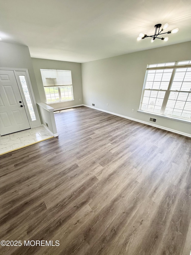 37 Tennyson Rd, Brick, NJ 08724 - unfurnished living room with a chandelier, wood finished floors, and baseboards