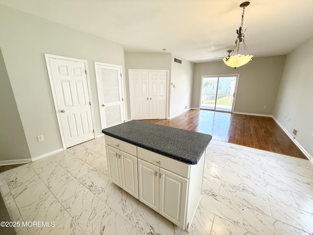 37 Tennyson Rd, Brick, NJ 08724 - kitchen with light marble finish flooring, white cabinets, and baseboards