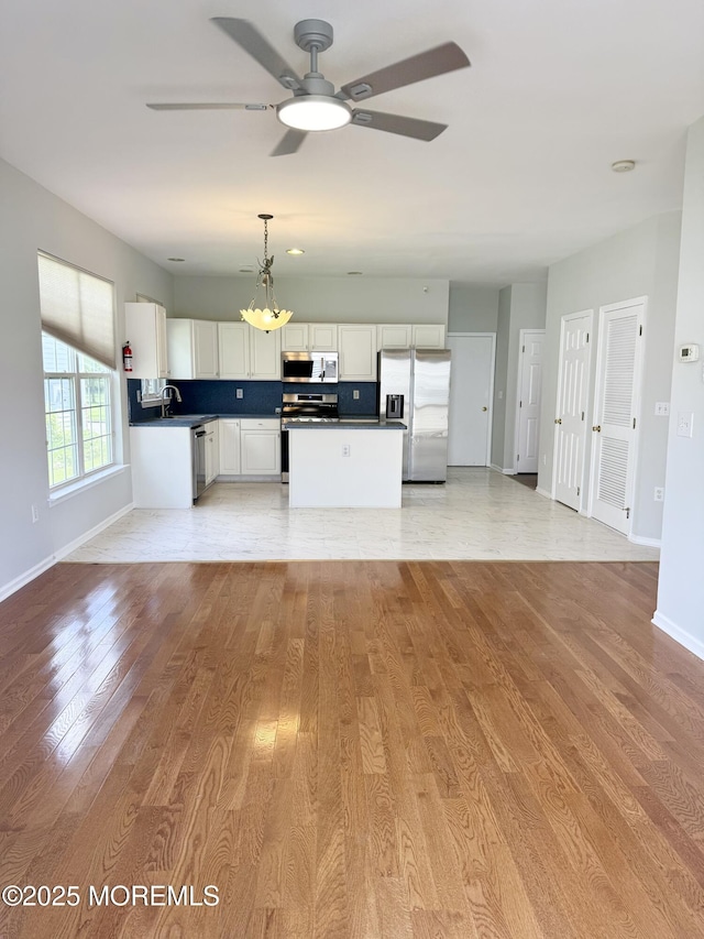 37 Tennyson Rd, Brick, NJ 08724 - kitchen featuring appliances with stainless steel finishes, a sink, ceiling fan, dark countertops, and baseboards