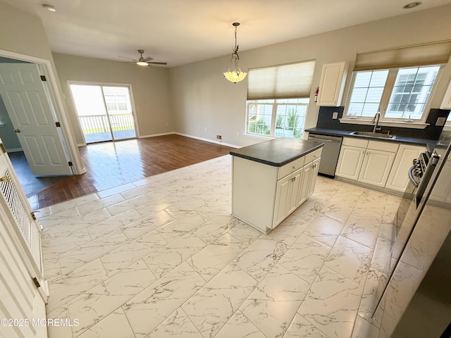 37 Tennyson Rd, Brick, NJ 08724 - kitchen featuring stainless steel dishwasher, a sink, a ceiling fan, dark countertops, and light marble finish floors